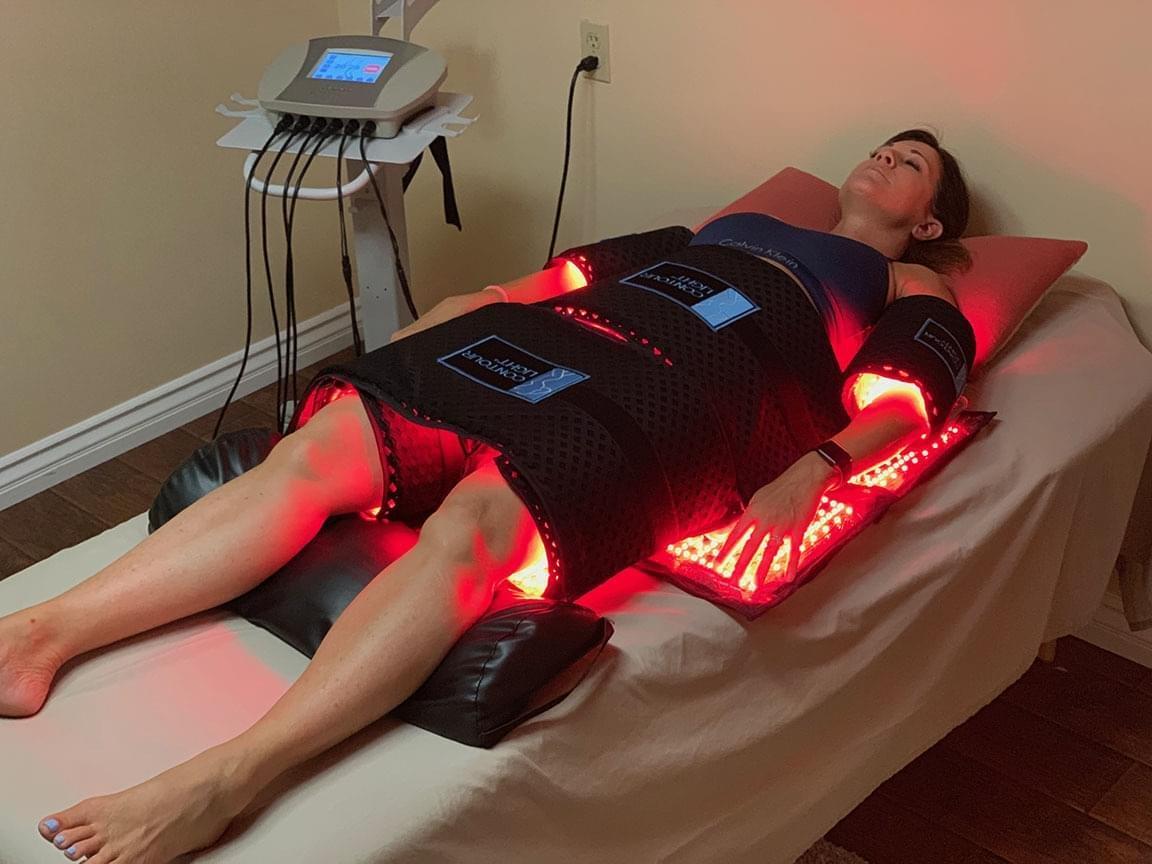 Female client experiencing a red light weight loss treatment done