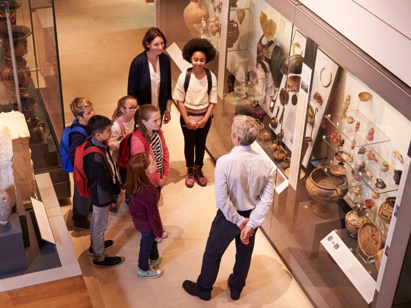 group of people listening to a tour guide in the museum