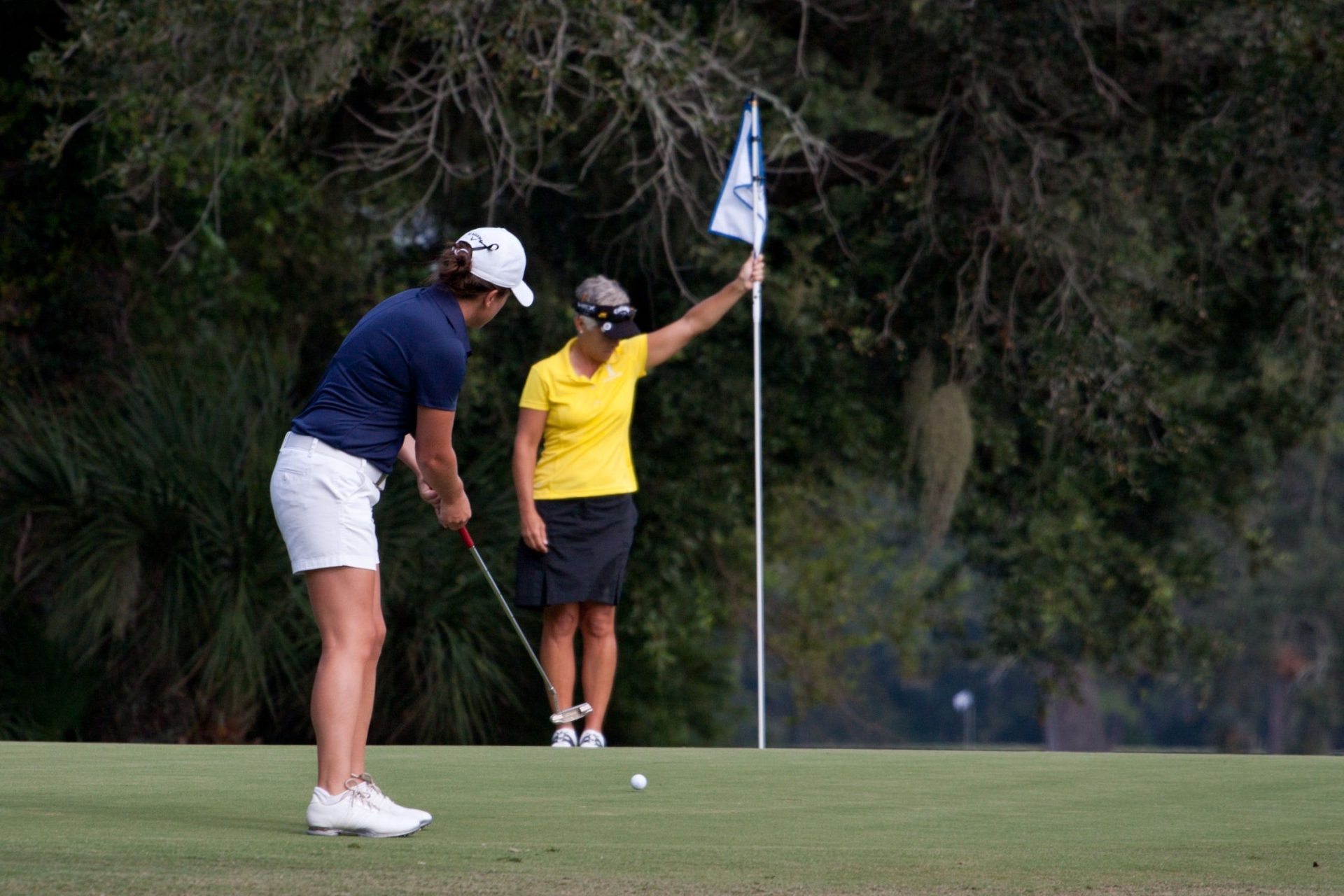 two women playing golf together
