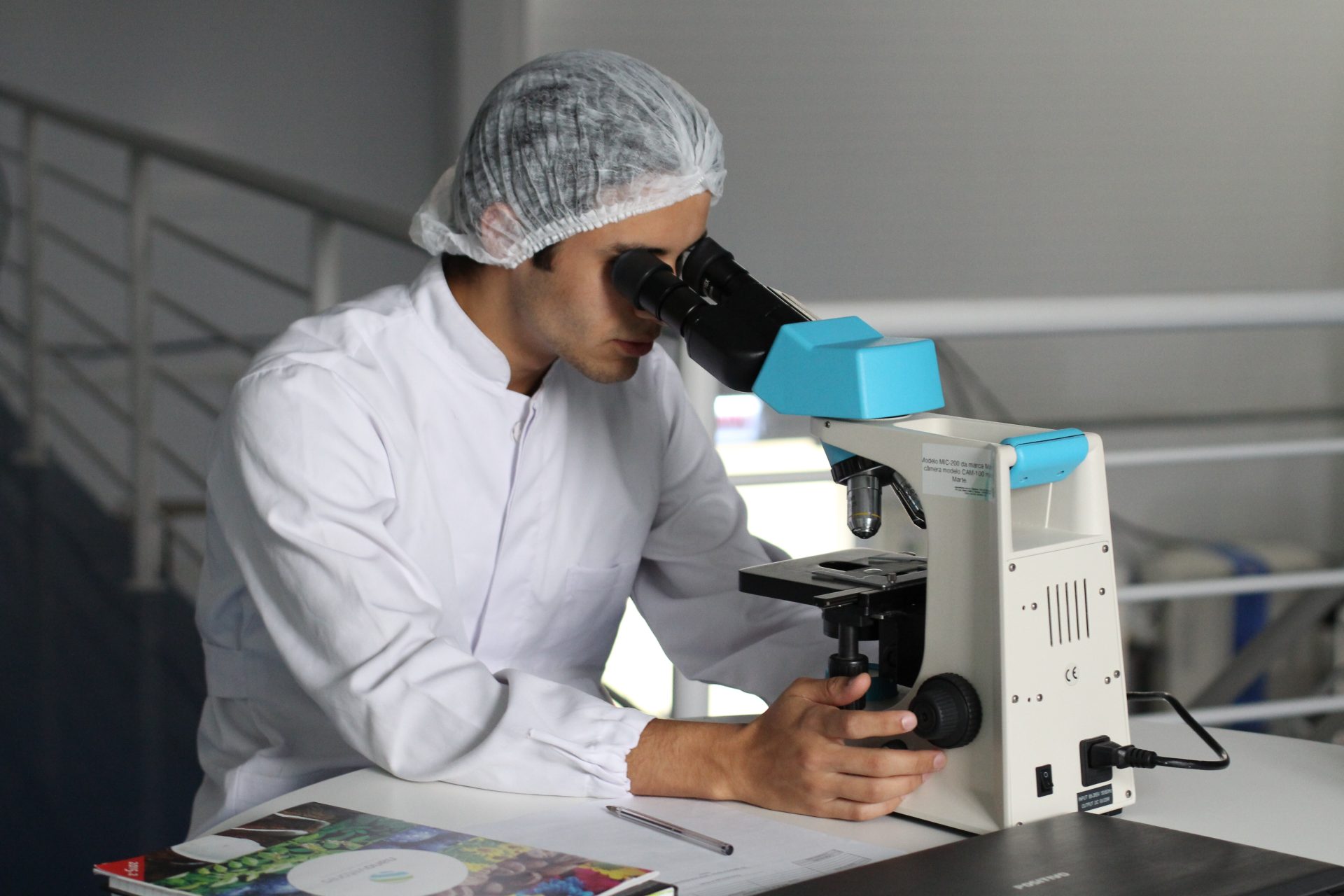 a man handling a microscope